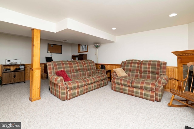 carpeted living area featuring wainscoting, wood walls, and recessed lighting