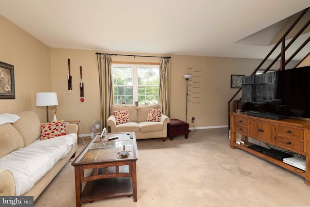 carpeted living area with baseboards