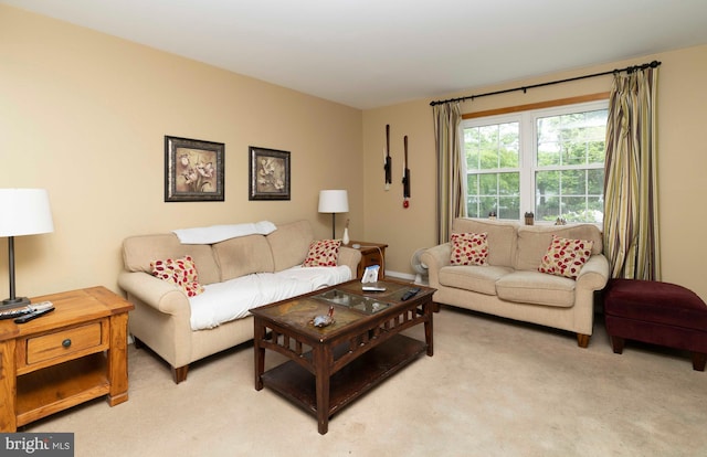 living area featuring light carpet