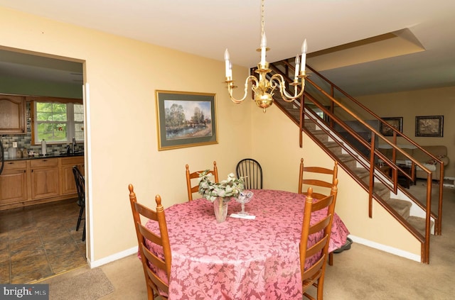 dining space with baseboards, stairs, dark carpet, and a chandelier