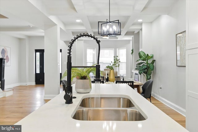 2424 W Lanvale St, Baltimore, MD 21216 - kitchen with coffered ceiling, light countertops, light wood-style flooring, pendant lighting, and baseboards