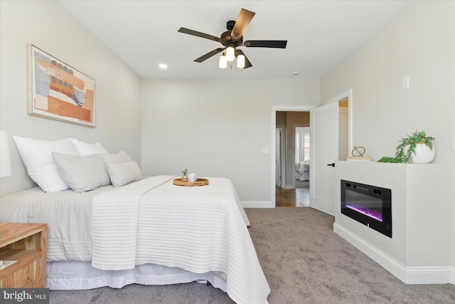 2424 W Lanvale St, Baltimore, MD 21216 - bedroom with carpet floors, a glass covered fireplace, baseboards, ceiling fan, and recessed lighting