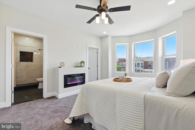 2424 W Lanvale St, Baltimore, MD 21216 - bedroom featuring carpet floors, a glass covered fireplace, baseboards, recessed lighting, and ensuite bathroom