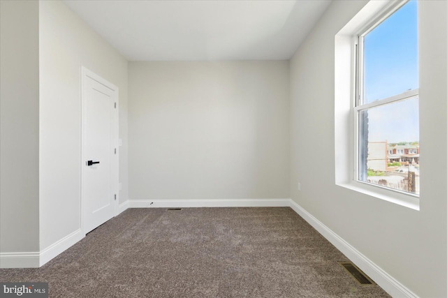 2424 W Lanvale St, Baltimore, MD 21216 - spare room with dark colored carpet, plenty of natural light, and baseboards