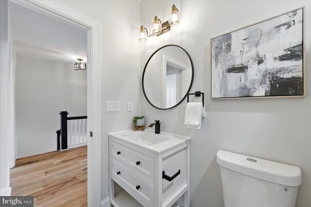 2424 W Lanvale St, Baltimore, MD 21216 - half bath with wood finished floors, toilet, and vanity