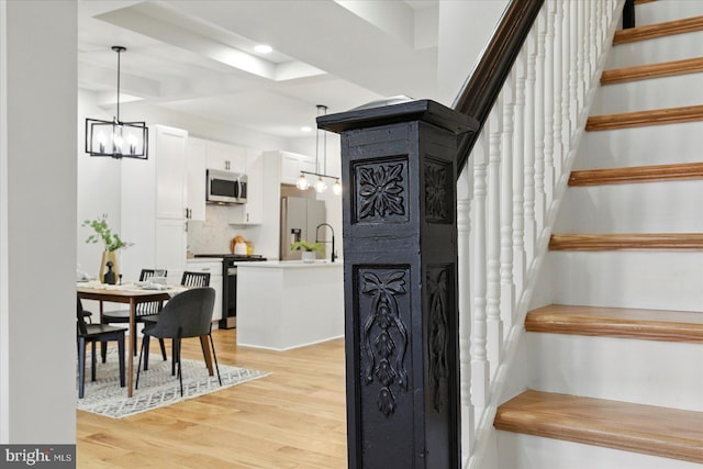 2424 W Lanvale St, Baltimore, MD 21216 - staircase featuring a chandelier, wood finished floors, and recessed lighting
