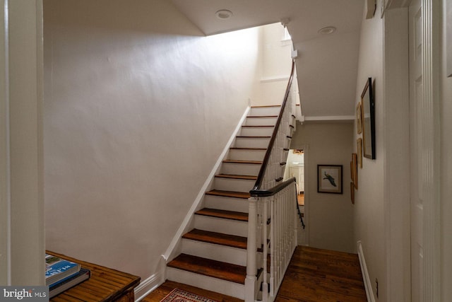 stairs featuring wood finished floors