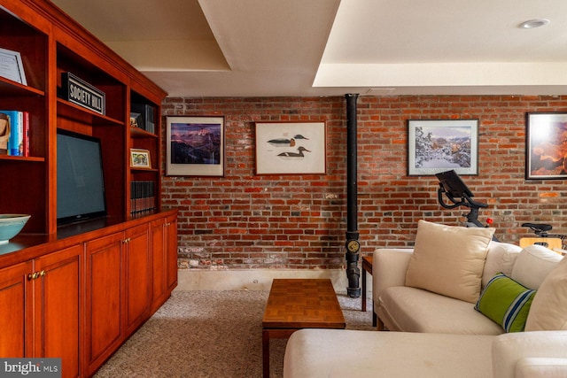 living area featuring brick wall