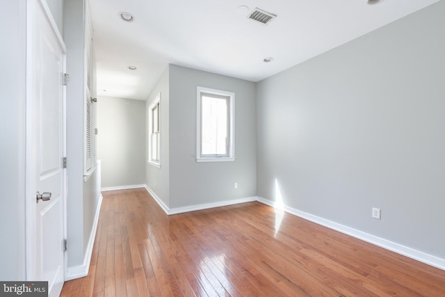 unfurnished bedroom featuring light wood finished floors, baseboards, and visible vents