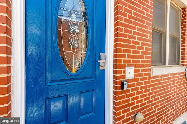 doorway to property with brick siding