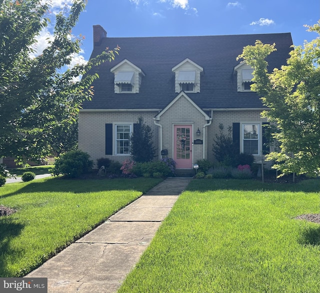 1606 N Market St, Frederick, MD 21701 - cape cod house with brick siding, a front lawn, and a shingled roof