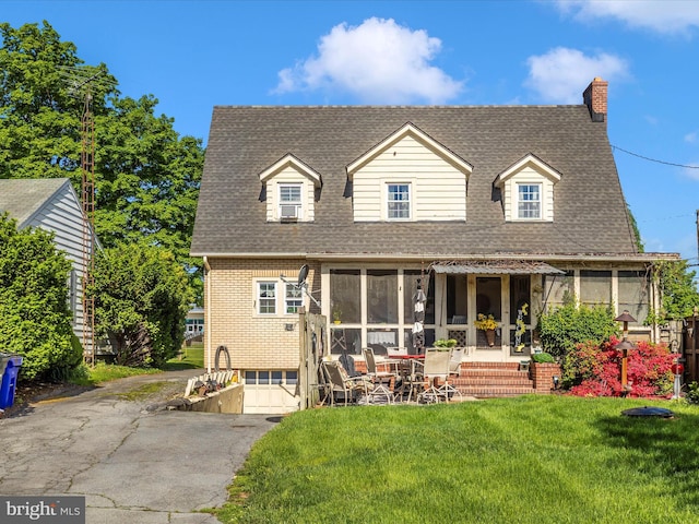 1606 N Market St, Frederick, MD 21701 - back of house featuring a shingled roof, a chimney, a yard, asphalt driveway, and an attached garage