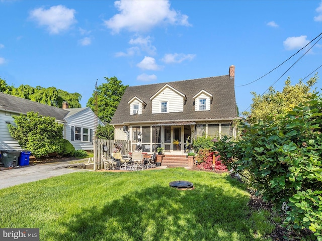 1606 N Market St, Frederick, MD 21701 - back of house with a sunroom and a lawn