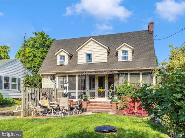 1606 N Market St, Frederick, MD 21701 - view of front of house featuring a sunroom, a front yard, a chimney, roof with shingles, and a patio area