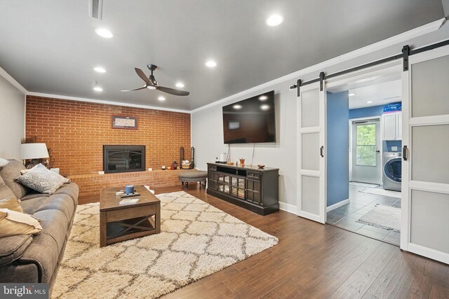 6404 Yates Ford Rd, Manassas, VA 20111 - living room featuring washer / dryer, a barn door, ceiling fan, crown molding, and dark wood finished floors