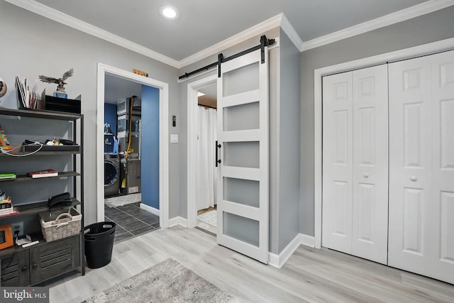 6404 Yates Ford Rd, Manassas, VA 20111 - mudroom featuring wood finished floors, a barn door, washer / dryer, crown molding, and baseboards