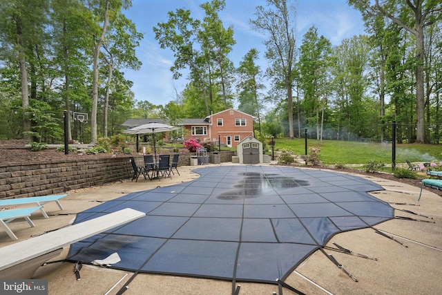 6404 Yates Ford Rd, Manassas, VA 20111 - view of pool featuring a shed, a patio area, an outdoor structure, fence, and view of scattered trees