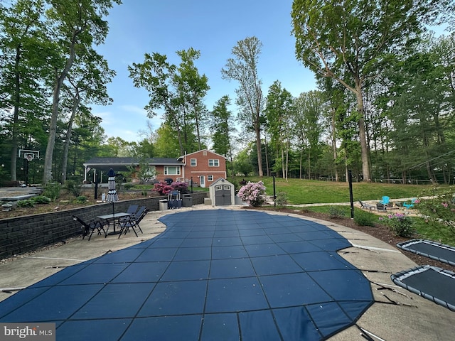 6404 Yates Ford Rd, Manassas, VA 20111 - view of swimming pool with a shed, a patio, an outdoor structure, and view of wooded area