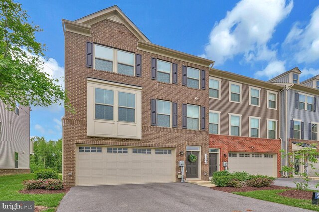 14540 Grace Kellen Ave, Brandywine, MD 20613 - townhome / multi-family property with an attached garage, brick siding, and asphalt driveway