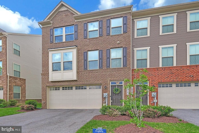 14540 Grace Kellen Ave, Brandywine, MD 20613 - townhome / multi-family property featuring asphalt driveway, brick siding, and an attached garage