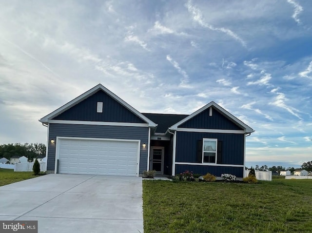 view of front of house with concrete driveway, a garage, and a front lawn