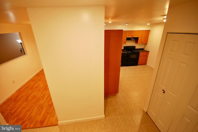 hall with baseboards and recessed lighting