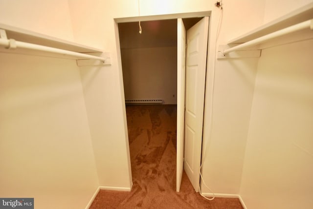 spacious closet featuring baseboard heating and carpet floors