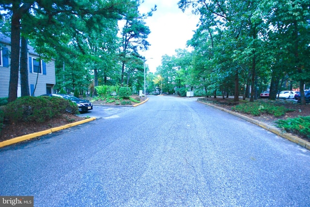 view of street with street lighting and curbs