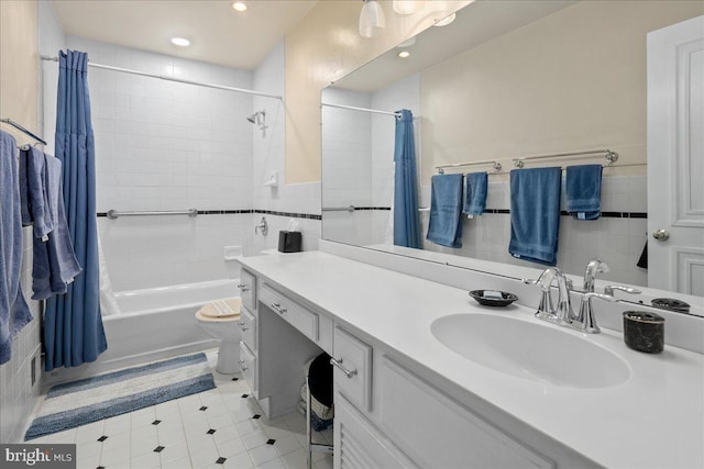 8513 Bound Brook Ln, Alexandria, VA 22309 - bathroom with tile walls, recessed lighting, shower / tub combo with curtain, vanity, and wainscoting
