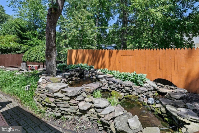 8513 Bound Brook Ln, Alexandria, VA 22309 - view of yard featuring fence and a garden pond