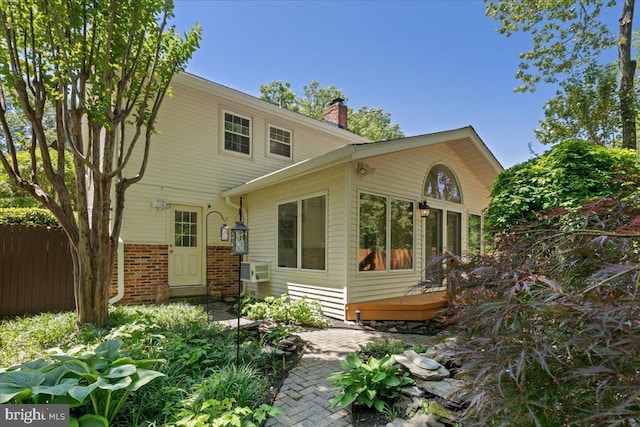 8513 Bound Brook Ln, Alexandria, VA 22309 - rear view of house with a chimney, fence, and brick siding
