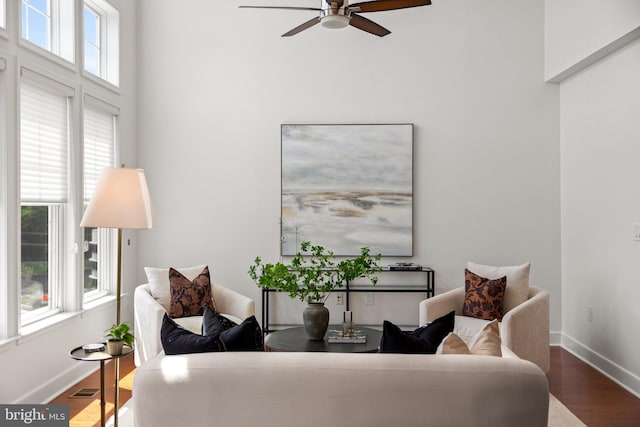 1418 N Rhodes St Unit B401, Arlington, VA 22209 - living area featuring a ceiling fan, wood finished floors, baseboards, and a towering ceiling