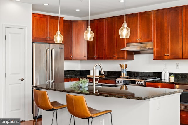 1418 N Rhodes St Unit B401, Arlington, VA 22209 - kitchen featuring a sink, under cabinet range hood, stainless steel appliances, an island with sink, and hanging light fixtures