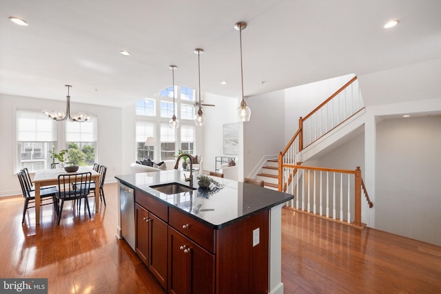 1418 N Rhodes St Unit B401, Arlington, VA 22209 - kitchen featuring a sink, wood finished floors, stainless steel dishwasher, a chandelier, and hanging light fixtures