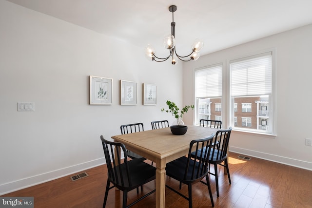 1418 N Rhodes St Unit B401, Arlington, VA 22209 - dining area featuring a chandelier, baseboards, and dark wood-type flooring