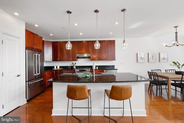 1418 N Rhodes St Unit B401, Arlington, VA 22209 - kitchen with appliances with stainless steel finishes, wood finished floors, a sink, a breakfast bar, and recessed lighting