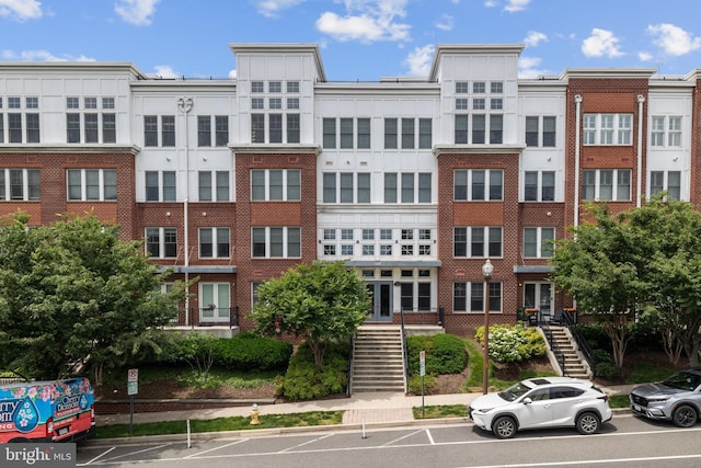 1418 N Rhodes St Unit B401, Arlington, VA 22209 - view of building exterior featuring stairway and uncovered parking
