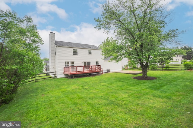 back of house with a deck and a chimney