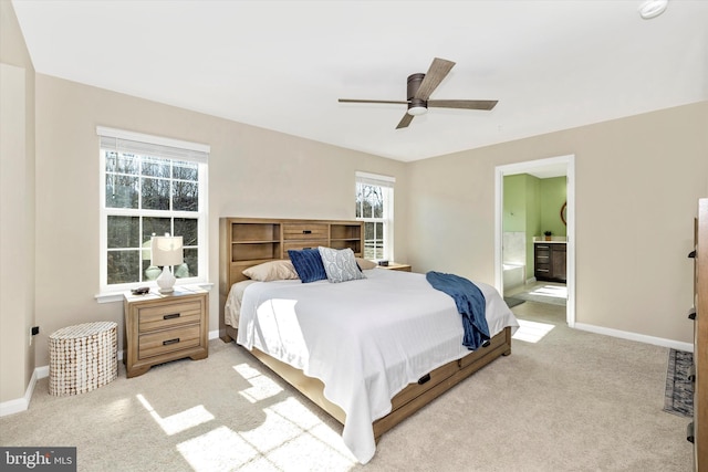 5609 Zoe Ln, Frederick, MD 21704 - bedroom featuring light colored carpet, ensuite bath, and baseboards