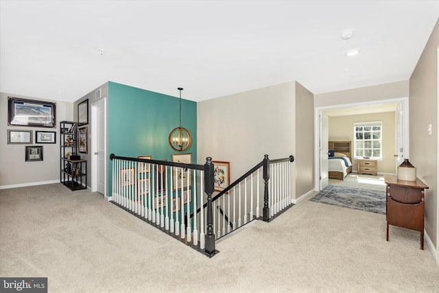 5609 Zoe Ln, Frederick, MD 21704 - corridor with an inviting chandelier, carpet, baseboards, and an upstairs landing