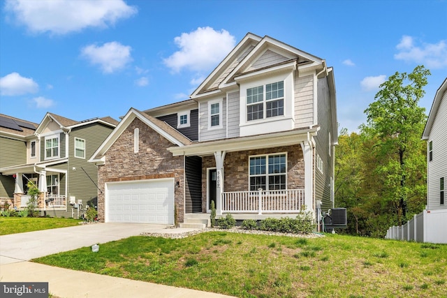 5609 Zoe Ln, Frederick, MD 21704 - view of front of property featuring covered porch, stone siding, a garage, central AC unit, and driveway