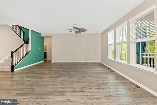 5609 Zoe Ln, Frederick, MD 21704 - unfurnished living room with baseboards, stairway, wood finished floors, and a ceiling fan