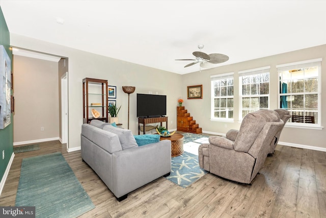 5609 Zoe Ln, Frederick, MD 21704 - living area featuring baseboards, stairway, ceiling fan, and wood finished floors