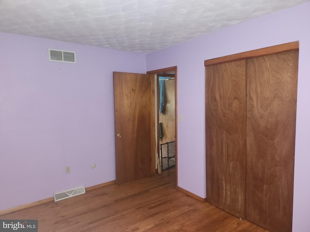 2153 Turnpike Rd, Elizabethtown, PA 17022 - unfurnished bedroom featuring wood finished floors, baseboards, a textured ceiling, and a closet
