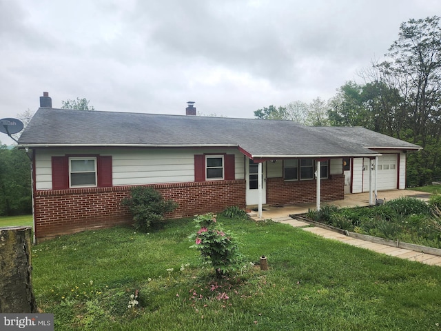 2153 Turnpike Rd, Elizabethtown, PA 17022 - ranch-style home featuring a garage, brick siding, and a front yard