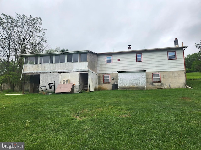 2153 Turnpike Rd, Elizabethtown, PA 17022 - back of property featuring a sunroom, a yard, cooling unit, and a chimney