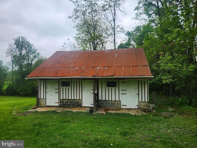 2153 Turnpike Rd, Elizabethtown, PA 17022 - back of property with a lawn, concrete block siding, metal roof, and an outbuilding