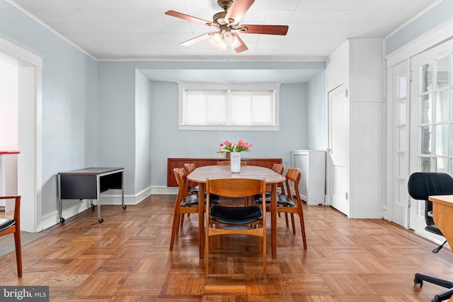 dining space with ceiling fan, crown molding, and baseboards