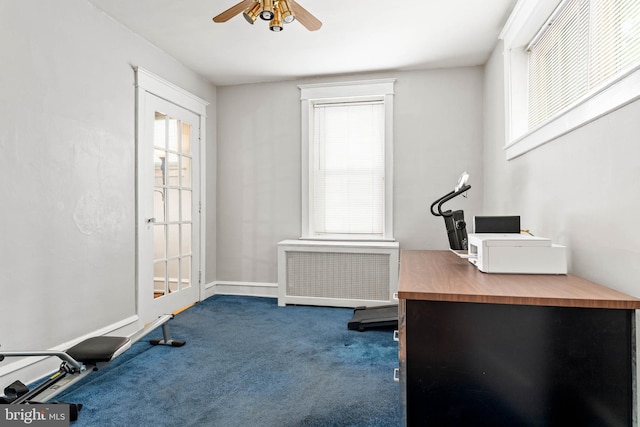 office space with radiator, carpet flooring, and plenty of natural light