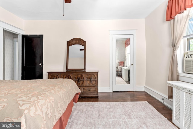 bedroom with dark wood-style flooring and baseboards